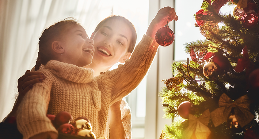 Holiday Sparkle: Mother and Daughter decorating the Christmas tree