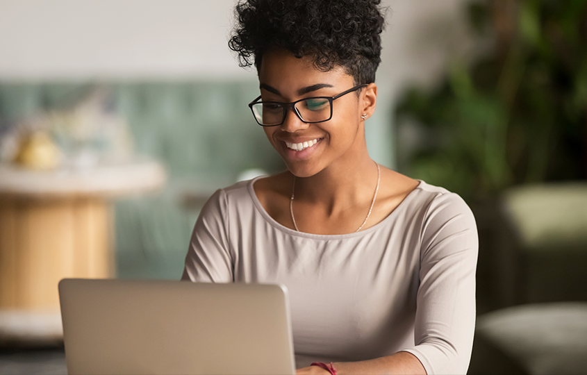 happy young woman working on her laptop